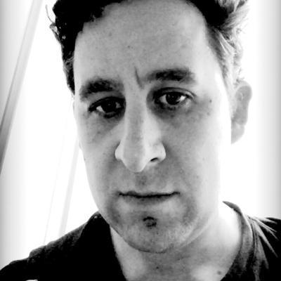 An avatar of Jacob Harris, it's a black and white photograph of his face